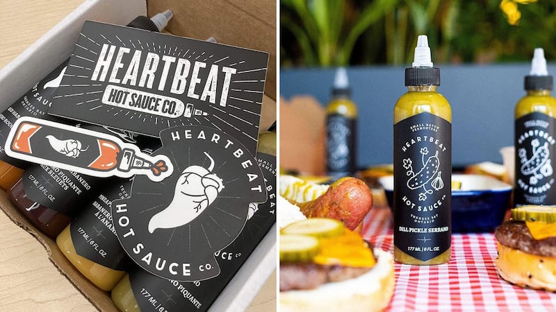Heartbeat Hot Sauce is packaged in a box with stickers and a bottle of dill pickle hot sauce on a table.